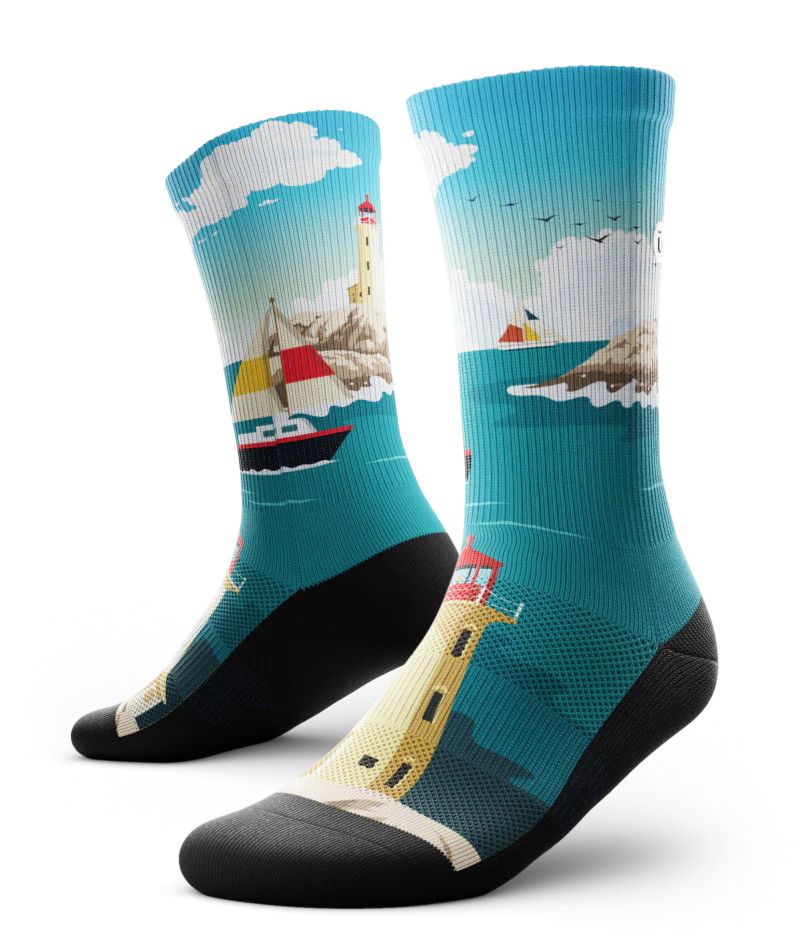 Outway performance crew socks with Peggy’s Cove lighthouse and ocean-inspired coastal graphics in blue and white tones.
