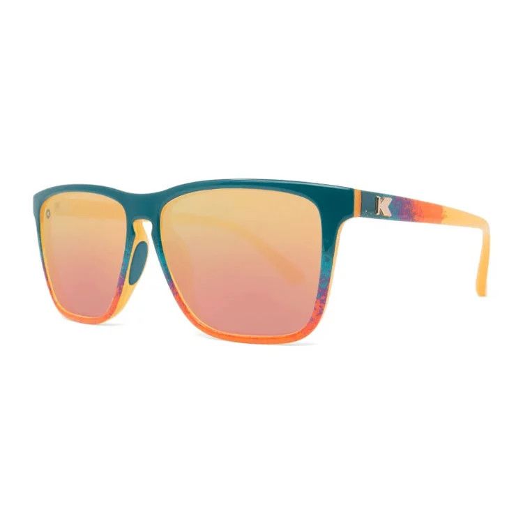 Sport sunglasses with a desert sunset fade design, polarized rose gold mirrored lenses, and teal rubber nose pads for secure 