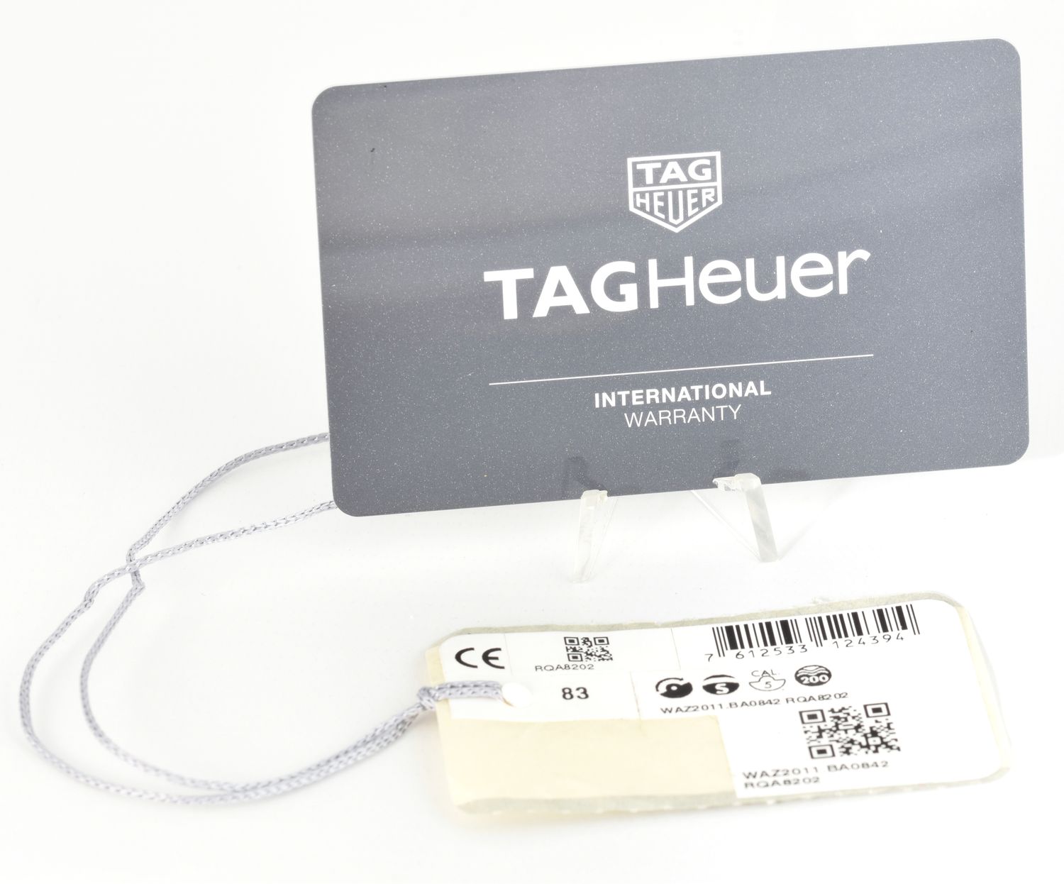 TAG Heuer Formula 1 WAZ2011.BA0842 international warranty card and swing tag with barcode, QR code, and reference numbers