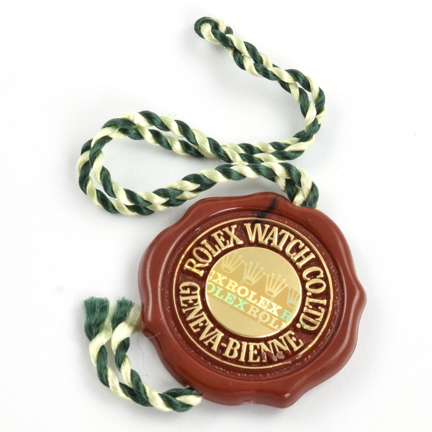 Rolex vintage red hologram watch swing hang tag with green and cream string, 25mm diameter