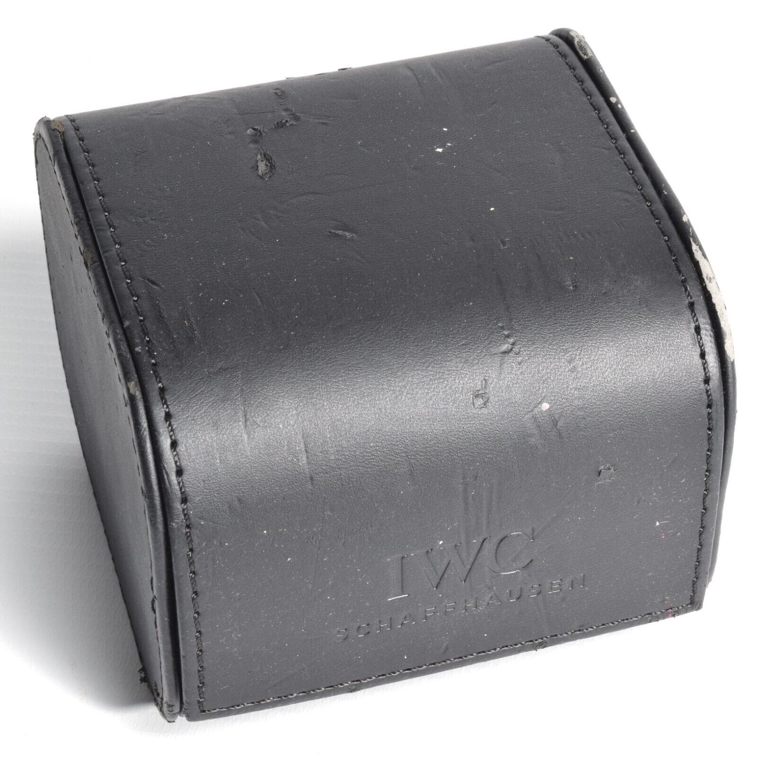 Genuine IWC travel watch box in black leather with embossed logo, showing signs of wear and peeling, no pillow included, dimensions 9cm x 7.5cm x 9cm