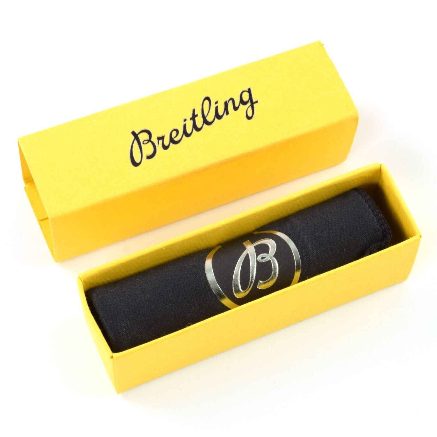 Yellow Breitling box with black interior containing a black polishing cloth wrapped with a silver “B” logo band, and the Breitling name printed on the lid in script font