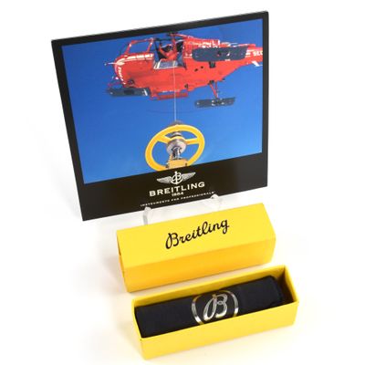 Breitling Emergency DVD and a Breitling polishing cloth in a yellow box.