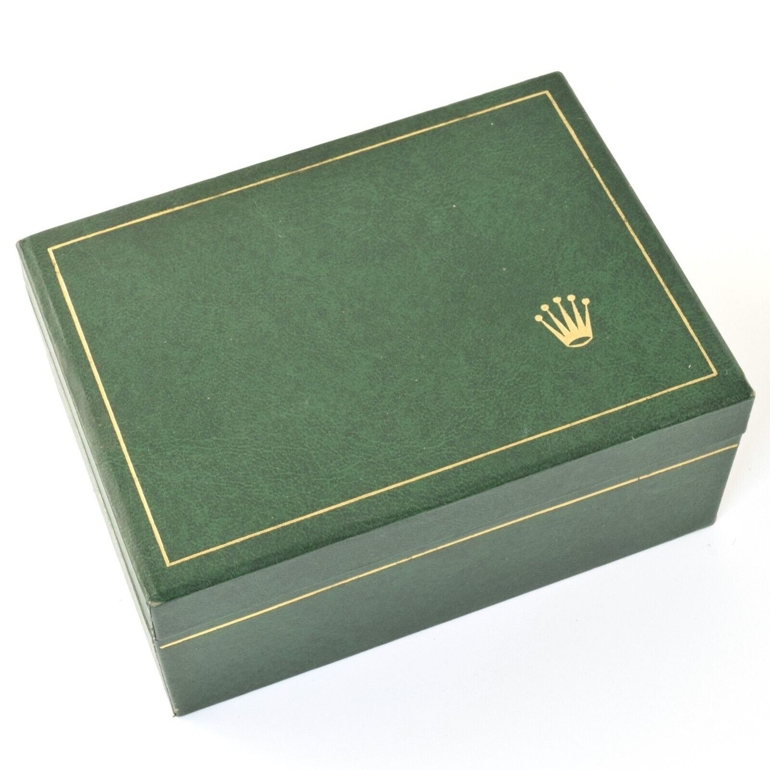 Green textured vintage Rolex watch box from the 1980s with gold trim and crown logo on the lid, showing visible wear