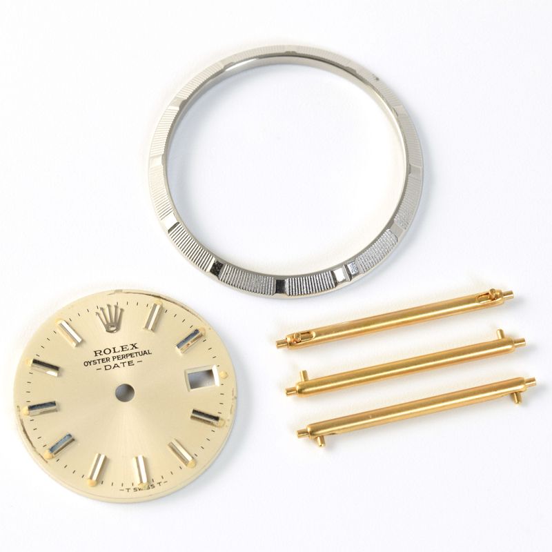 Rolex grooved bezel, Rolex golden watch dial, three gold Cartier quick release sprig bars