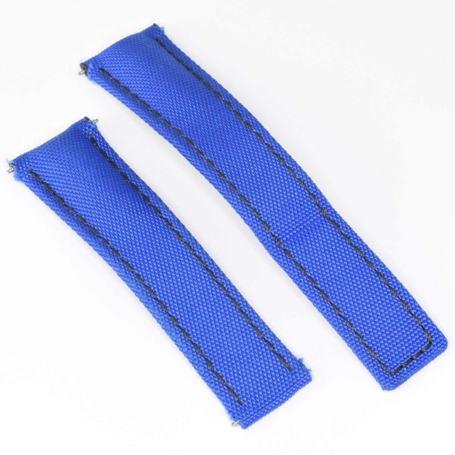 Genuine TAG Heuer Aquaracer watch strap reference FC6382 made from blue textile with black stitching and black calf leather underside shown from above with both strap pieces laid flat, 22mm at the watch end tapering to 18mm at the buckle end