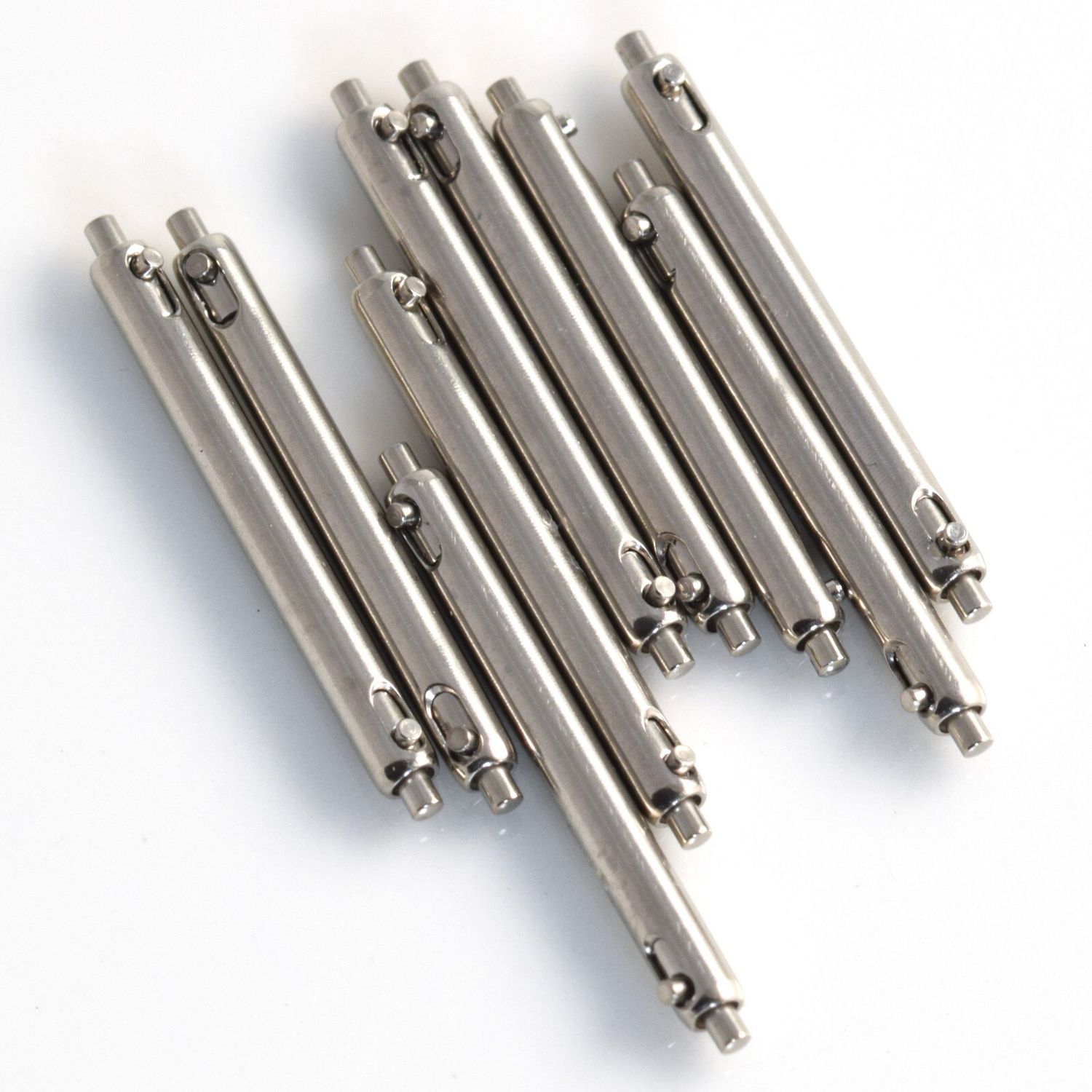 Set of 9 new authentic Cartier single shoulder quick release steel spring bars measuring 1.7mm x 17mm laid out on a white background, for use with Cartier Panthere Cougar model 987904 and other watches with 17mm lug width