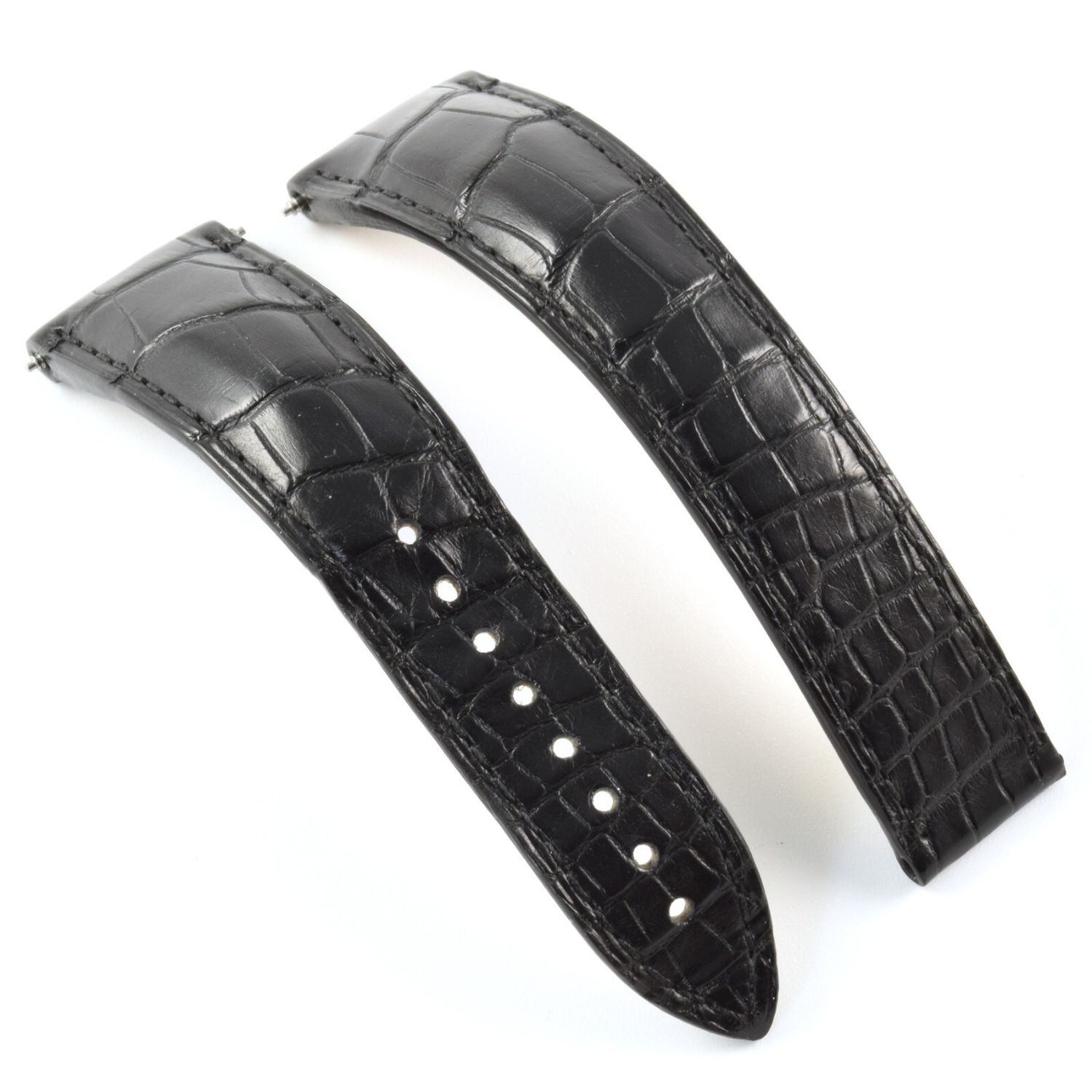 Omega Speedmaster Moonwatch black alligator watch strap, 20mm tapering to 16mm, showing the textured surface clearly and strap holes