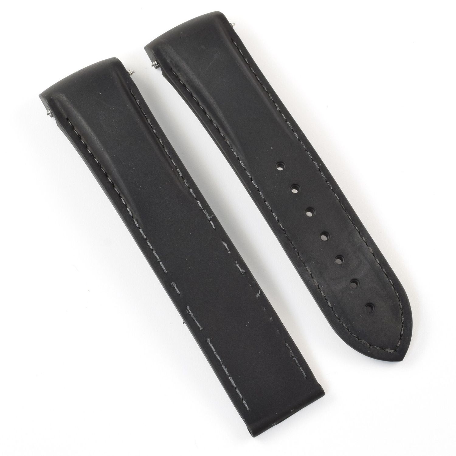 Omega Planet Ocean 45.5mm black rubber watch strap with visible white stitching and 7 sizing holes shown side-by-side with Omega part number 98000363