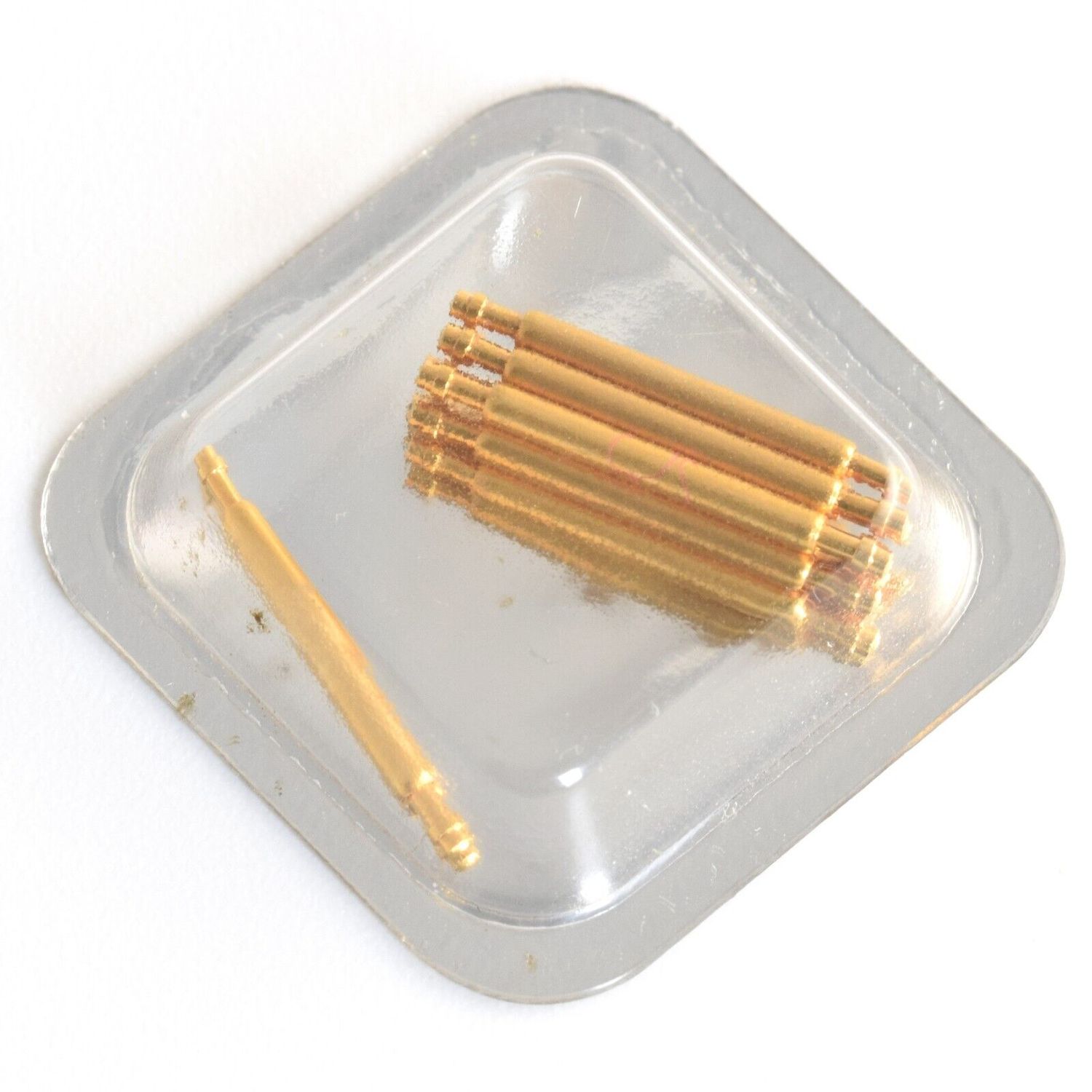 sealed blister pack containing 10 gold-plated spring bars for Cartier Tank Française MM DJ watch with one bar separated from the group under clear plastic