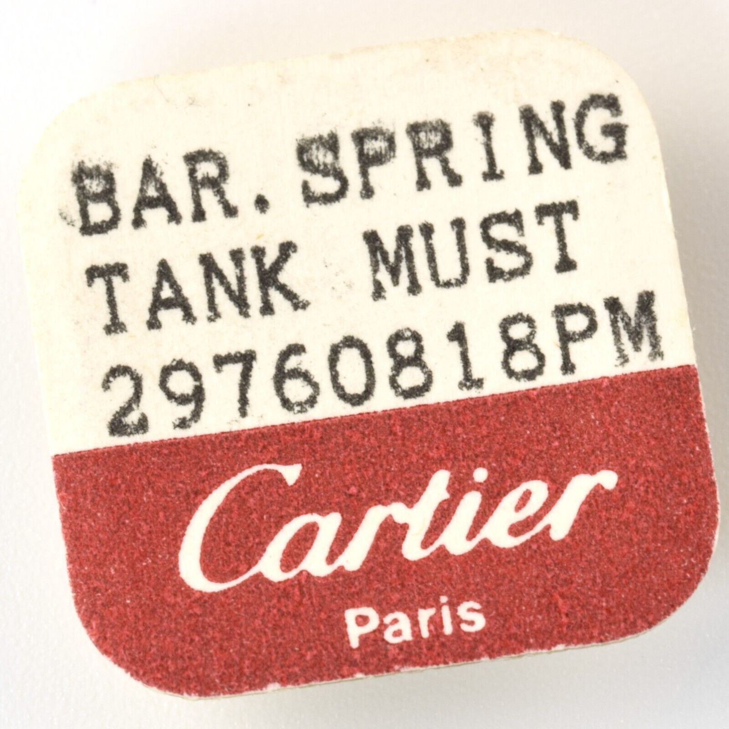 label from Cartier spring bar pack showing text “BAR. SPRING TANK MUST 29760818PM Cartier Paris” in black and white with red Cartier branding