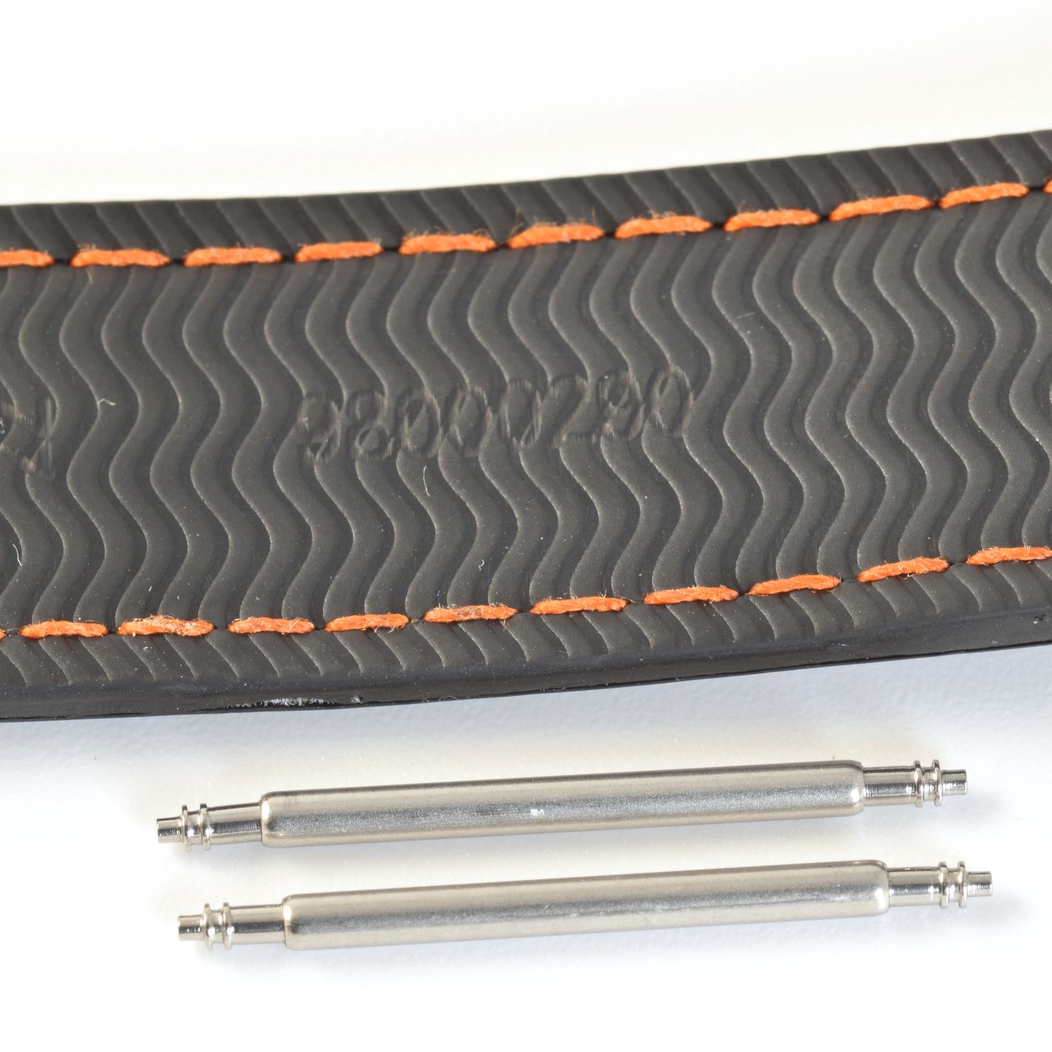 two stainless steel spring bars shown below Omega Seamaster rubber strap stamped 98000290 with wave pattern and orange stitching on white background