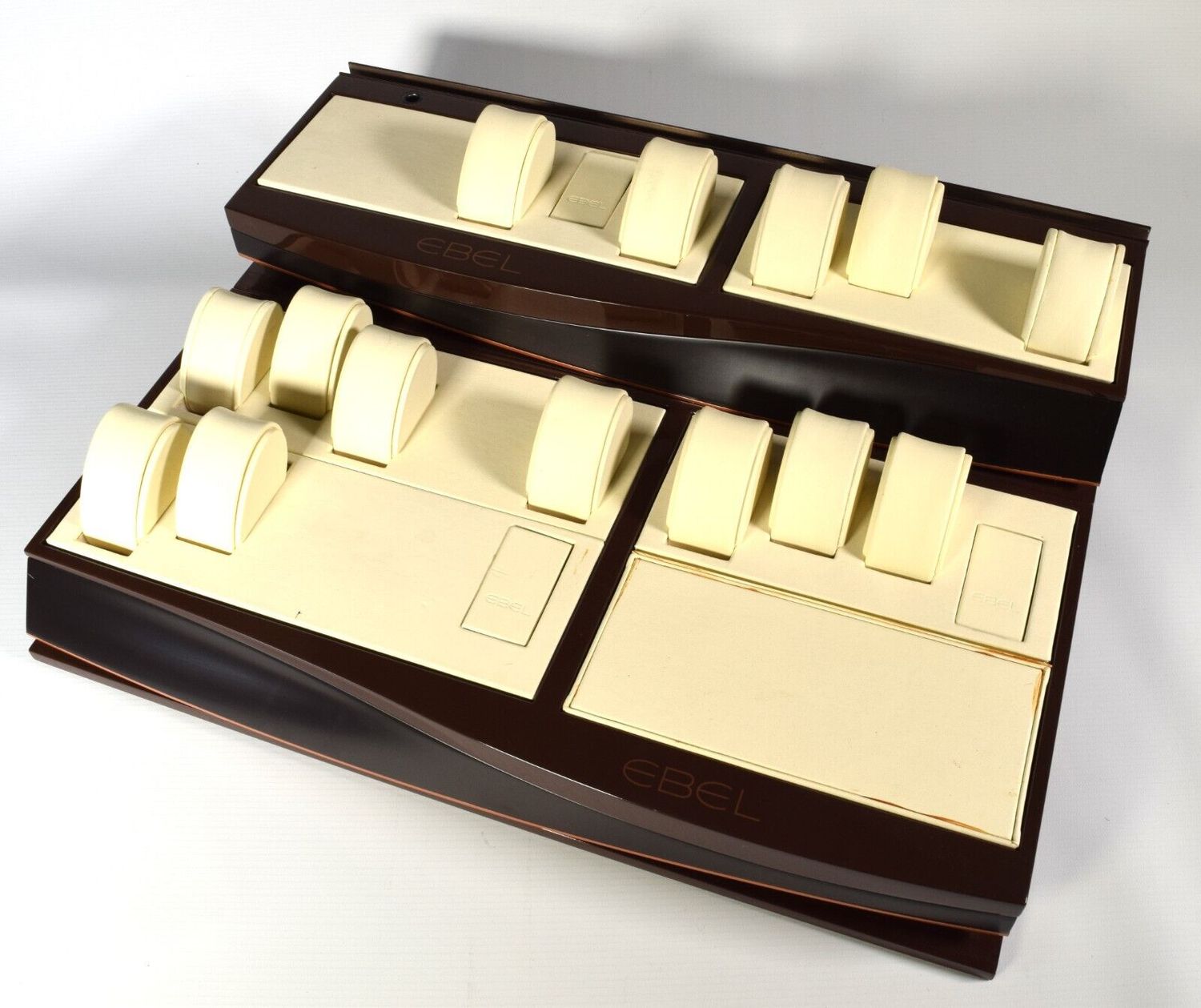 Large authentic EBEL watch display stand with brown frame, cream leather interior, 14 round cream leather watch pillows and 2 EBEL-marked plugs across a two-level layout