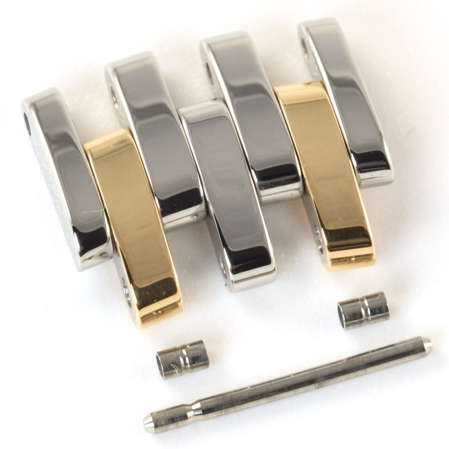 New and authentic Omega De Ville Prestige 32.7mm gold and steel watch strap link with five curved polished links, two of which are gold, shown with original Omega pin and two steel tubes