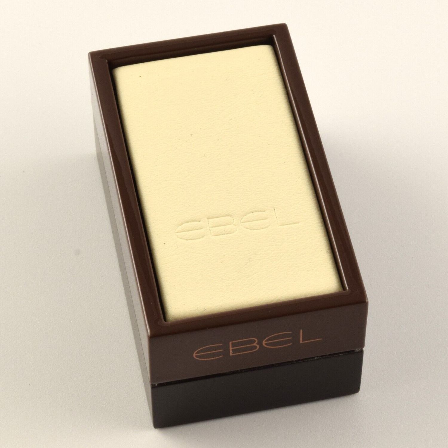 New authentic EBEL watch display stand with brown plastic base and cream leather top featuring embossed EBEL logo on both surfaces