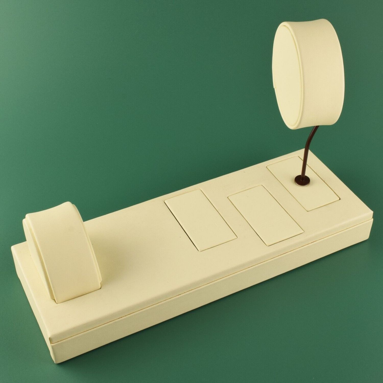 Authentic EBEL cream leather display tray with two round watch pillows and sockets on green background