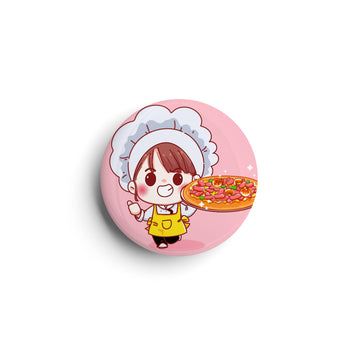 Orange badge/sticker/magnet with abstract design.
