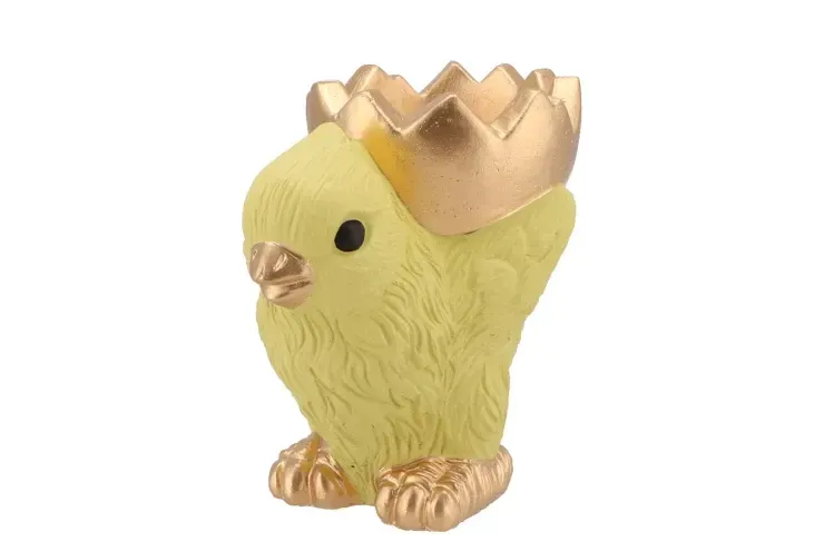 Geel kuiken met gouden eierdop