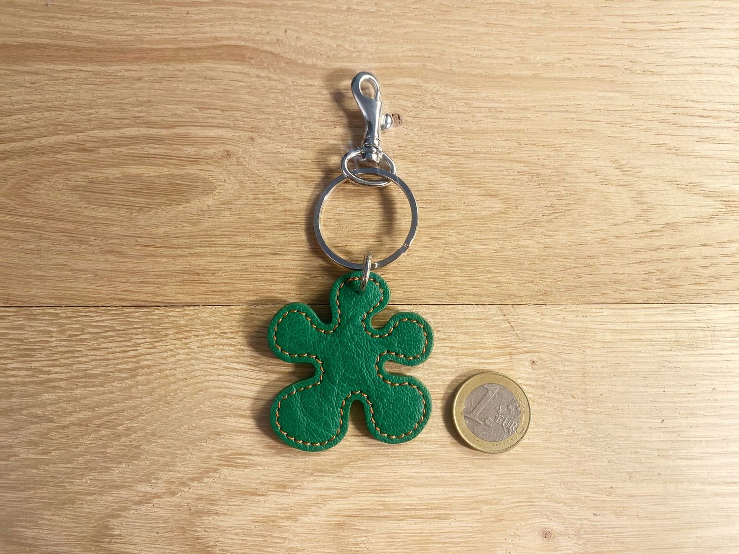 Porte-clefs fleur, buffle vert, surpiqué orange. Porte-clefs fleur, buffle vert, surpiqué orange.