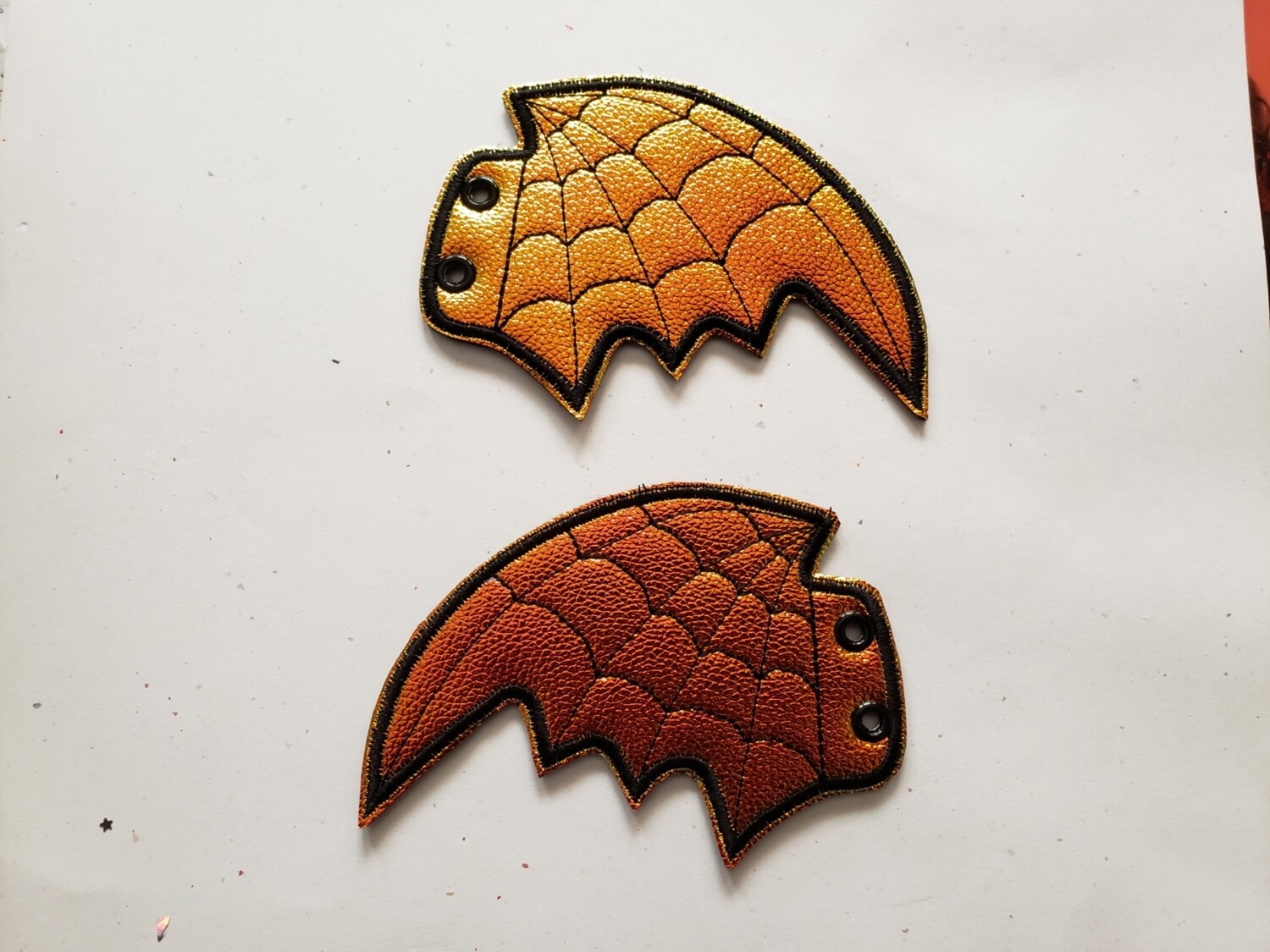 Bat skate wings in orange metallic shift with spiderweb stitching rts