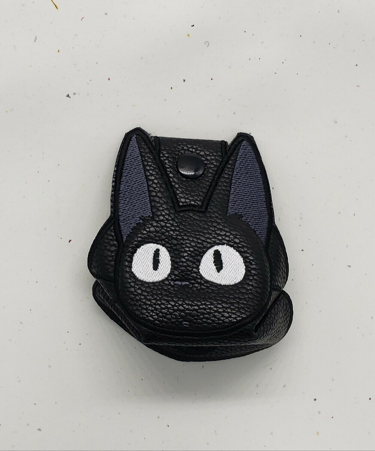 Cat from Kiki's delivery on black faux leather