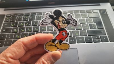 Embroidered iron-on patch icon with thread and needle, sketch style