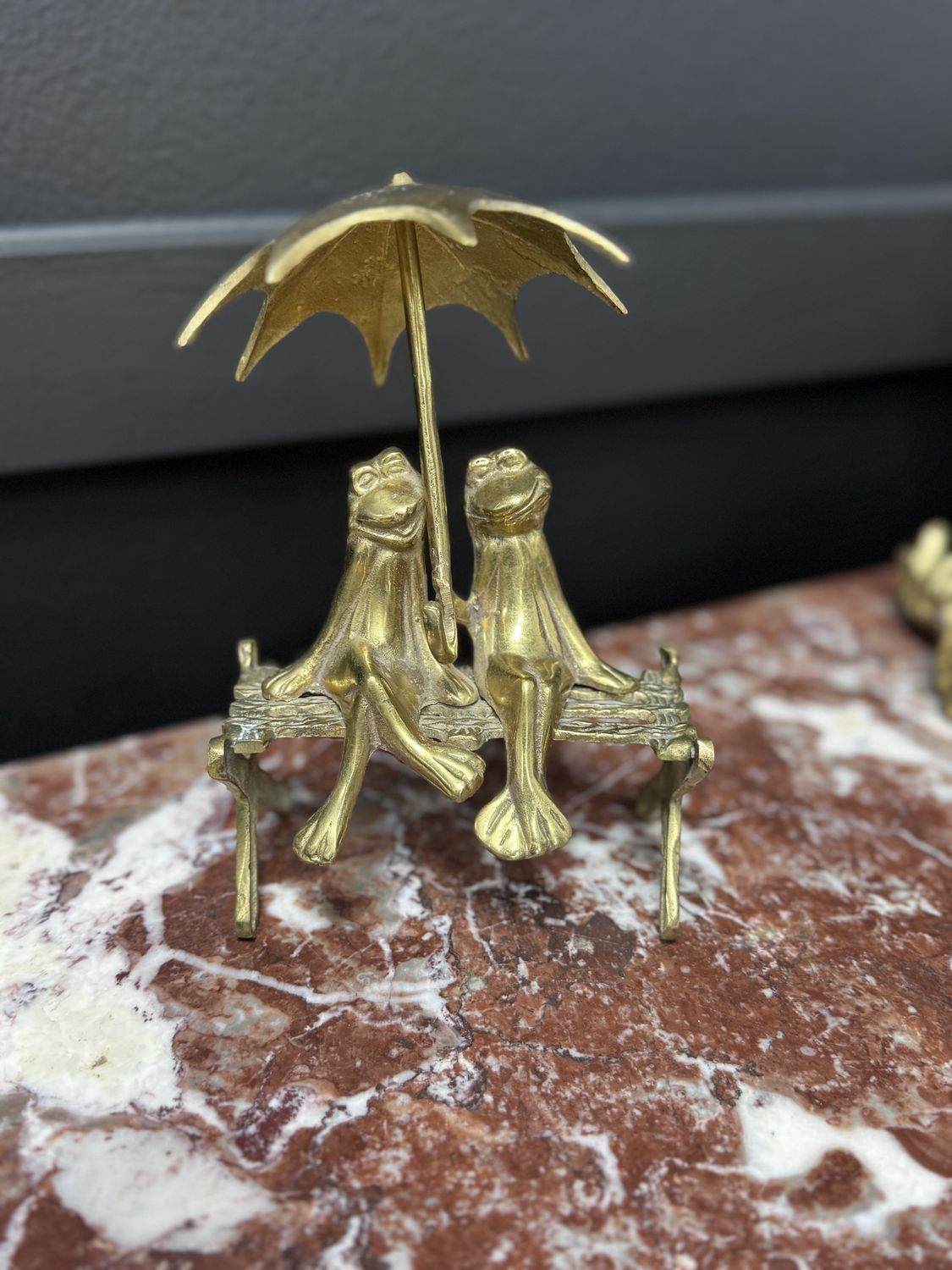 Brass frogs on bench