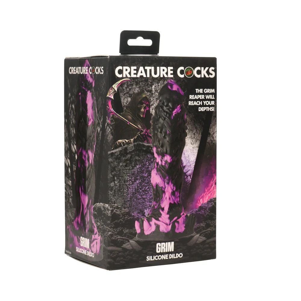 The Creature Cocks Grim Silicone Dildo, shown in its box in front of an illustration of a skeletal grim reaper. The dildo is marbled in purple and black, sporting a somewhat human shape with a tapered head with spiky ridges and waves along its length, ending with a ring of soft spikes along its base.