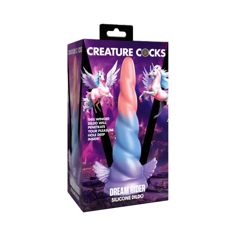 The front of the Creature Cocks Dream Rider Silicone Dildo box, depicting a peach, blue, and purple layered unicorn horn dildo with tiny wings on either side of the base, shown in front of a purple fantasy background and 2 illustrated alicorns.