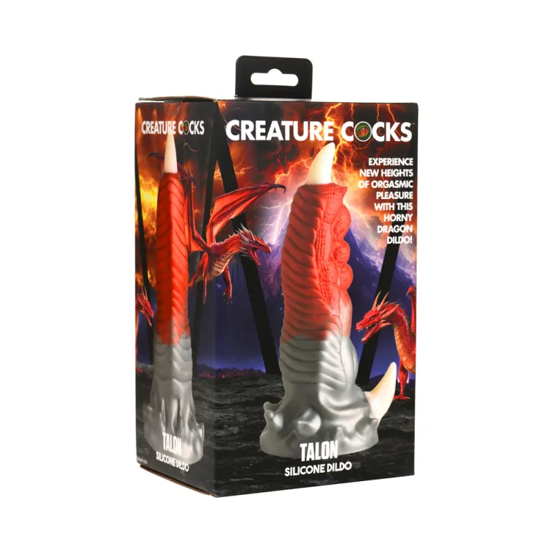 The Creature Cocks Talon silicone dildo in its box, depicted in front of an illustration of a red, classically styled dragon. The toy resembles a large taloned digit, shiny silver at the base and blending into a deep crimson at the top, tipped with a nubby off-white claw at the base and tip. 