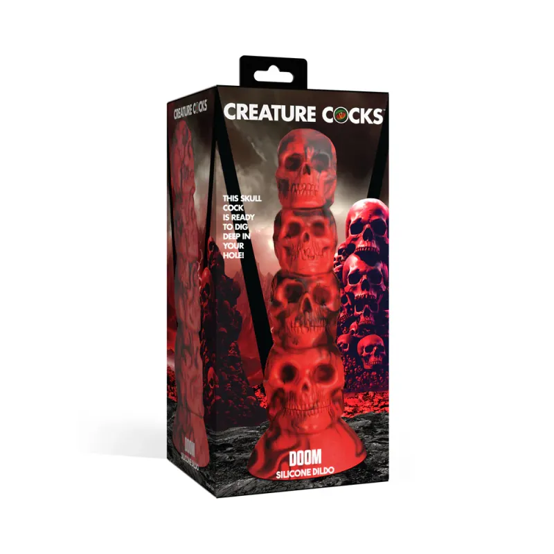 The front of the box of the Creature Cocks Doom, showing off a spiraled black and red silicone dildo in the shape of four unique skulls stacked from largest on top of its flared base to smallest at the tip of the toy. 