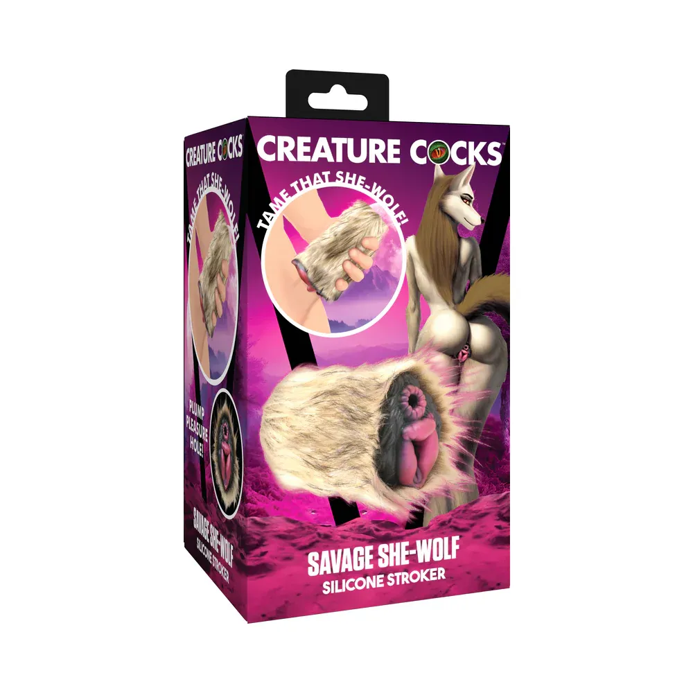 The Creature Cocks Savage She-Wolf Stroker in its box, depicted with an illustration of an anthropomorphic wolf woman with brown fur presenting her ass to the viewer. The stroker has a black base with a removable brown fur sleeve and two openings resembling the vagina and anus of a wolf. The vaginal open is somewhat larger with a puffy triangular opening, while the anus is a much smaller ring.