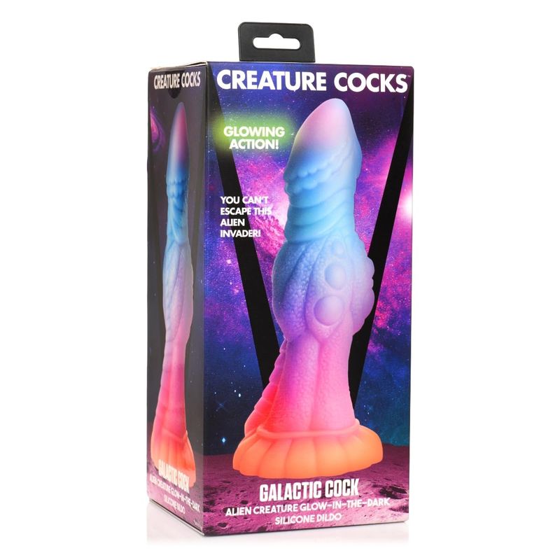 The Creature Cocks Galactic Cock Alien Creature dildo, depicted in its box. The toy is a 4 colored silicone dildo ranging from pink at the tip to blue, then purple, then pink once more, and finally orange at the base, with a somewhat humanoid tip descending into a ridged texture along the shaft and a prominent knot at its center, with a thick base for deeper play. 