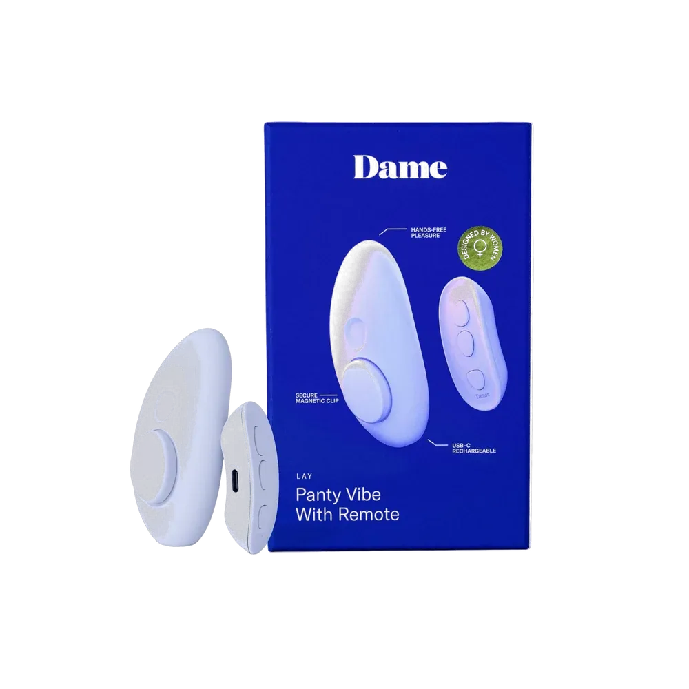 The Dame Lay, a lavender, oval-shaped panty vibe with a magnetic attachment, and its small remote, depicted beside its box
