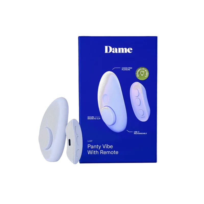 The Dame Lay, a lavender, oval-shaped panty vibe with a magnetic attachment, and its small remote, depicted beside its box