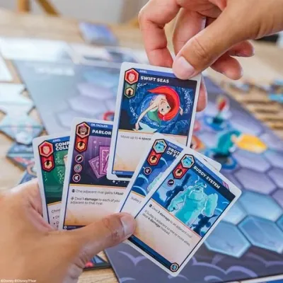 Disney Sorcerer’s Arena character cards being played during a game.