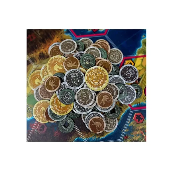 Scythe metal coins piled on the game board with different denominations and faction-style designs.
