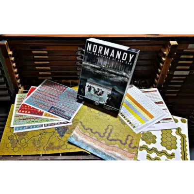 Normandy box, maps, overlays, charts, and player aids laid out on a table.