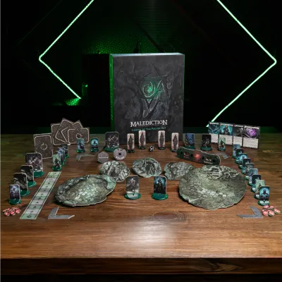 Malediction Legion of the Fallen faction box with cards, terrain, tokens, dice, and standees set up on a table.