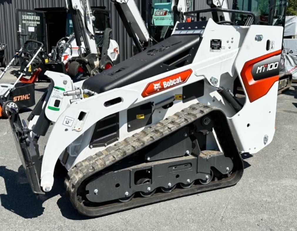Bobcat MT100 stand-on skid steer with implements: forks, stump grinder, trencher, Harley Rake Bobcat MT100 stand-on skid steer with implements: forks, stump grinder, trencher, Harley Rake