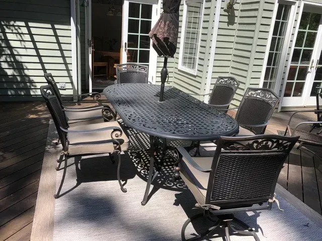 Miramar Dining Chairs with Outdoor Custom Cushions and Dining Table on a large back patio