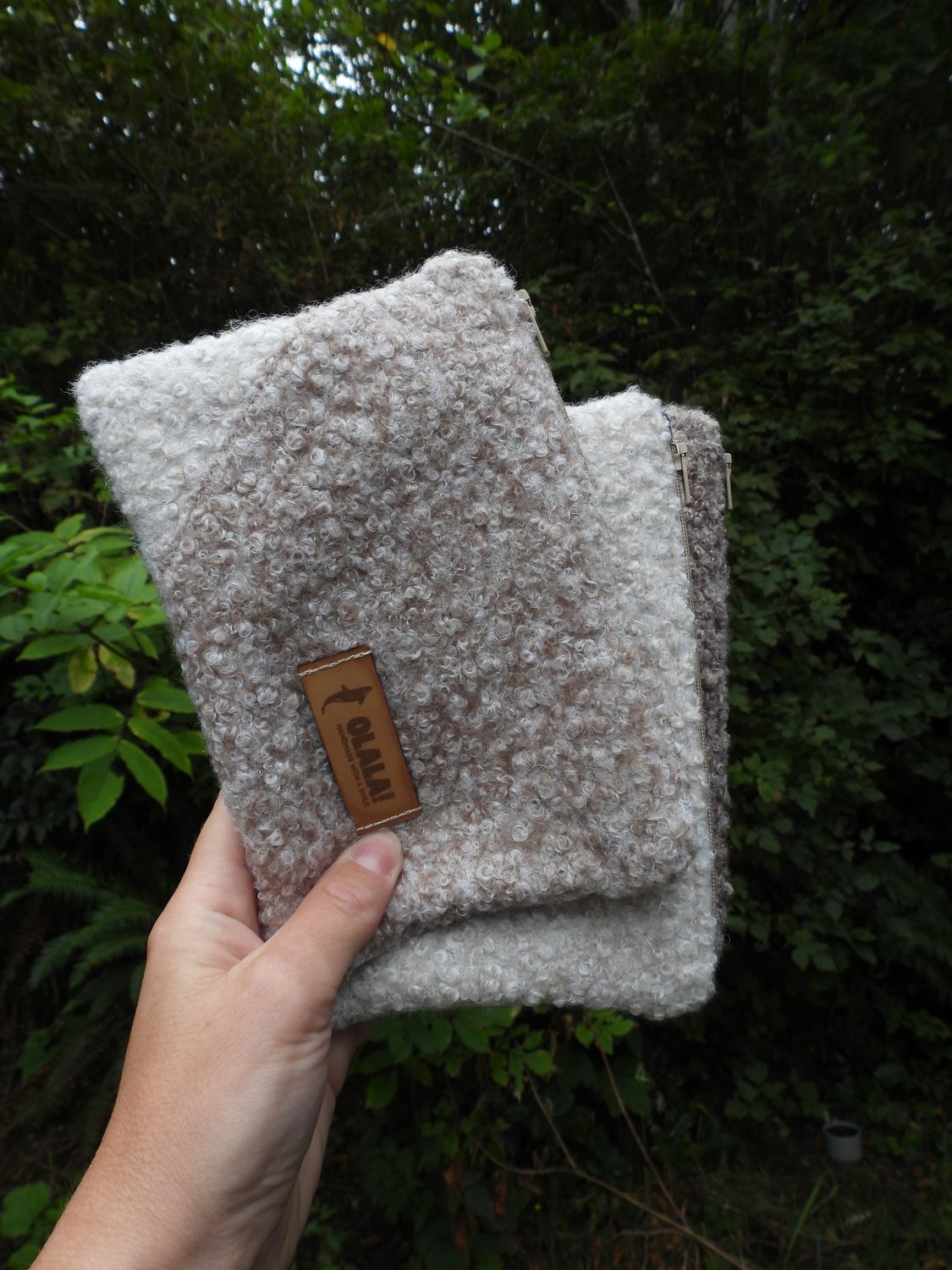 Handmade soft pouch by Olala! on Vancouver Island, boucle fabric, front view with a forest nature background. 