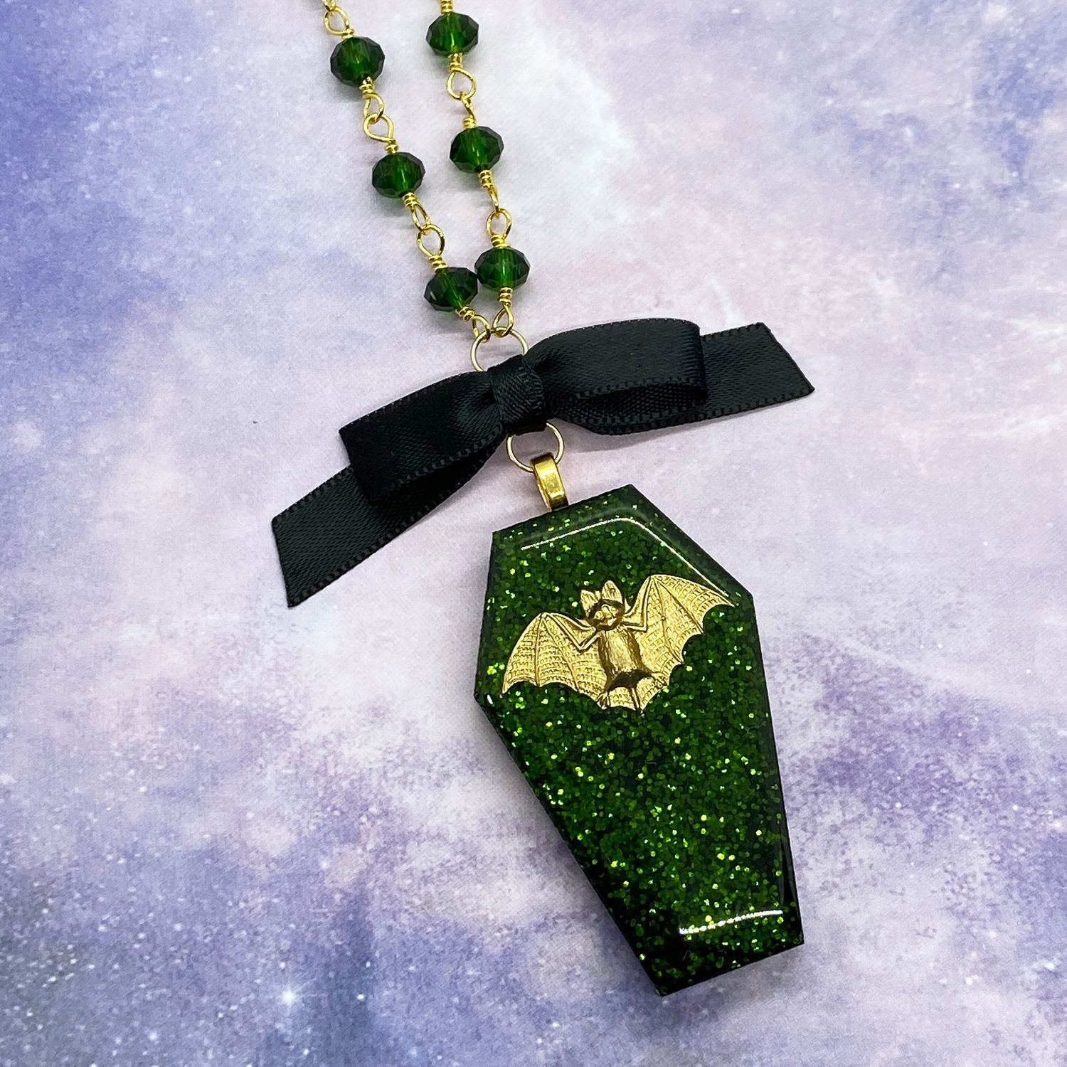 green glitter bat coffin necklace