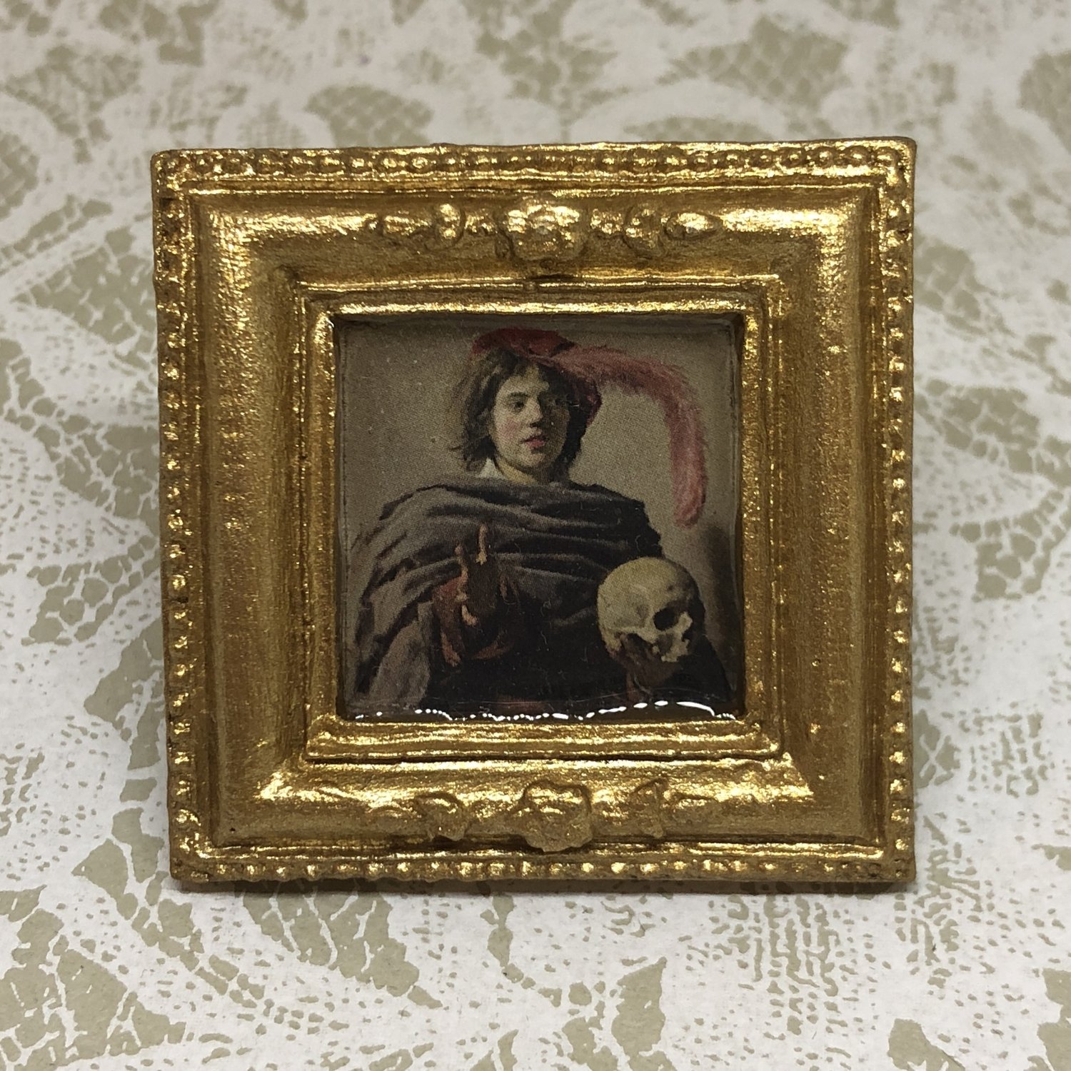 portrait frame brooch (young man with skull)
