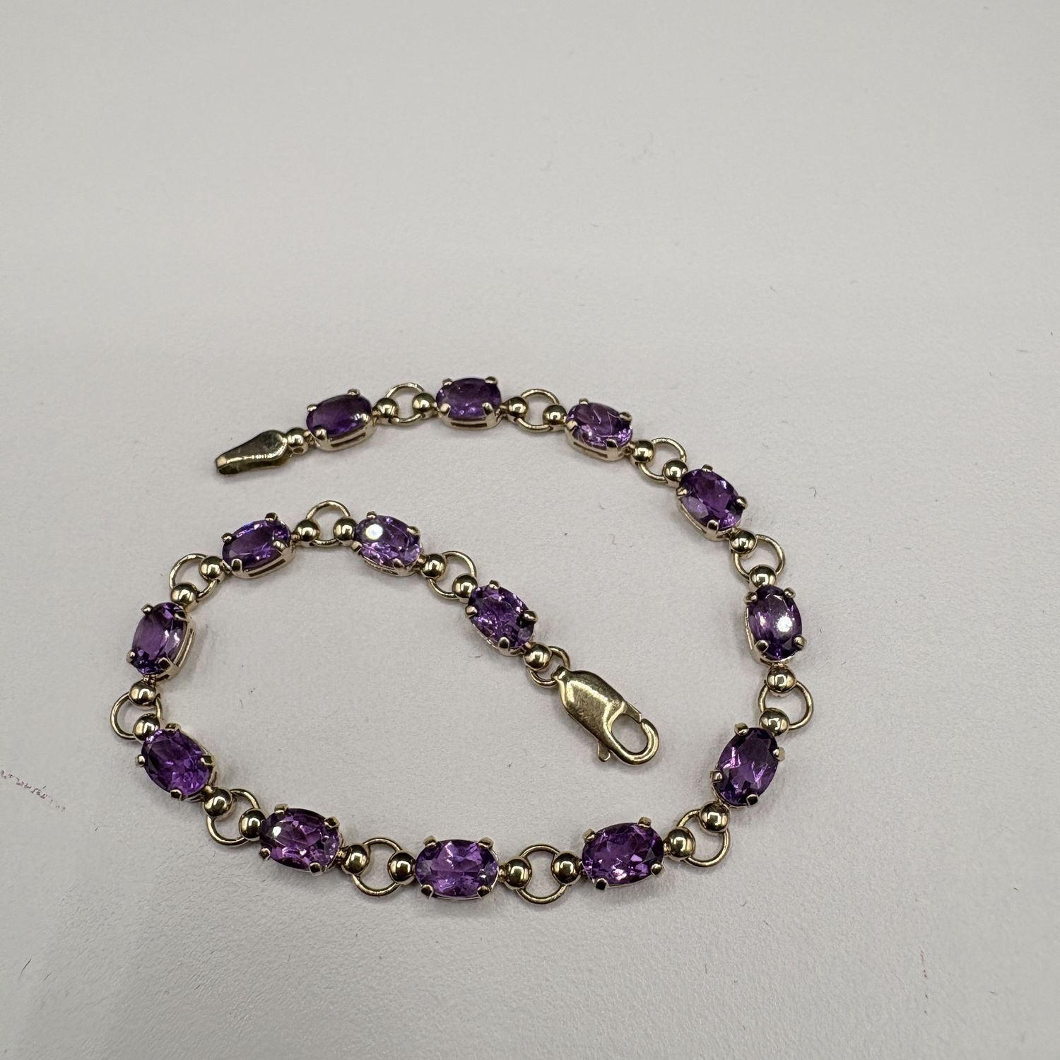 10K OVAL AMETHYST TENNIS BRACELET 7"