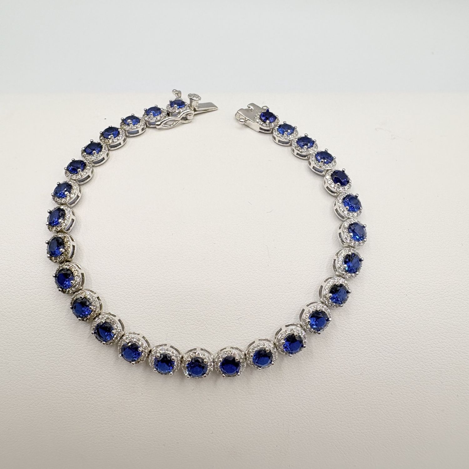 STERLING BLUE STONE WITH CZ HALO BRACELET 7.5"
