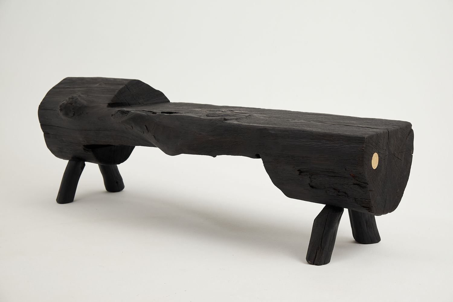 Jownik, Charred Wood Log Bench – Primitive Elegance in Burnt Timber Jownik, Charred Wood Log Bench – Primitive Elegance in Burnt Timber