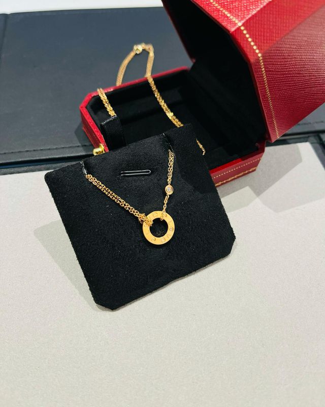 Gold Circle Pendant Necklace with Engraved Details and Diamond Accent