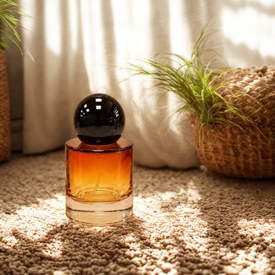 30 ml refillable perfume atomizer in amber thick toned glass with glossy black orb cap — fine mist spray, travel-ready, and gift-perfect.