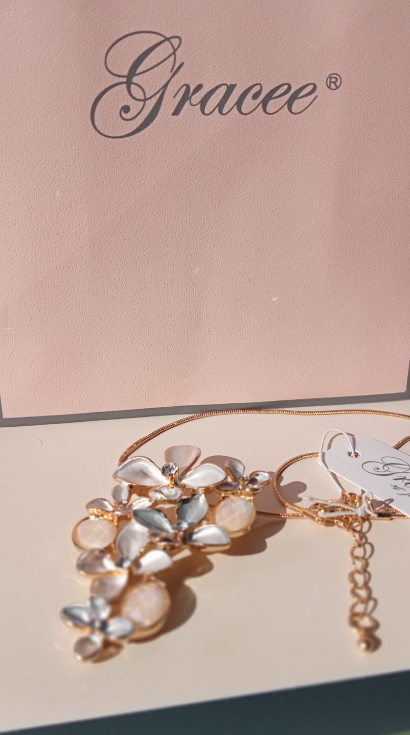 Gold tone flower pendant with diamante centre